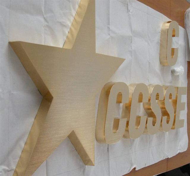 The brushed stainless steel letters are electroplated golden color